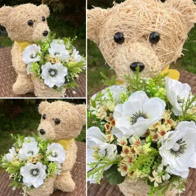 Child’s memorial teddy planter with yellow and cream artificial flowers